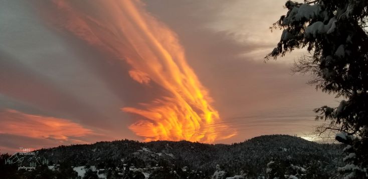 orange sunset over snowy mountains